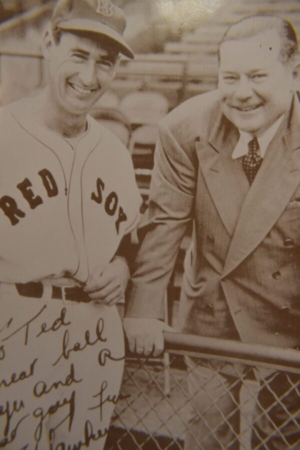 Two men, one in Red Sox uniform.