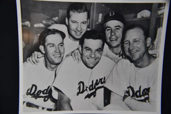 Four smiling Dodgers baseball players.