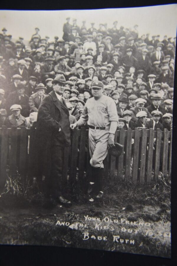 Babe Ruth with a crowd and a man.