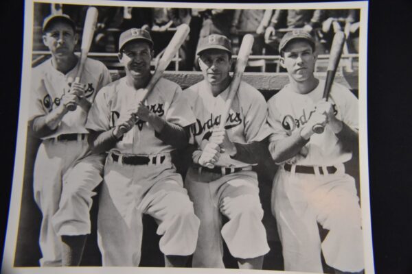 Four Dodgers baseball players holding bats.