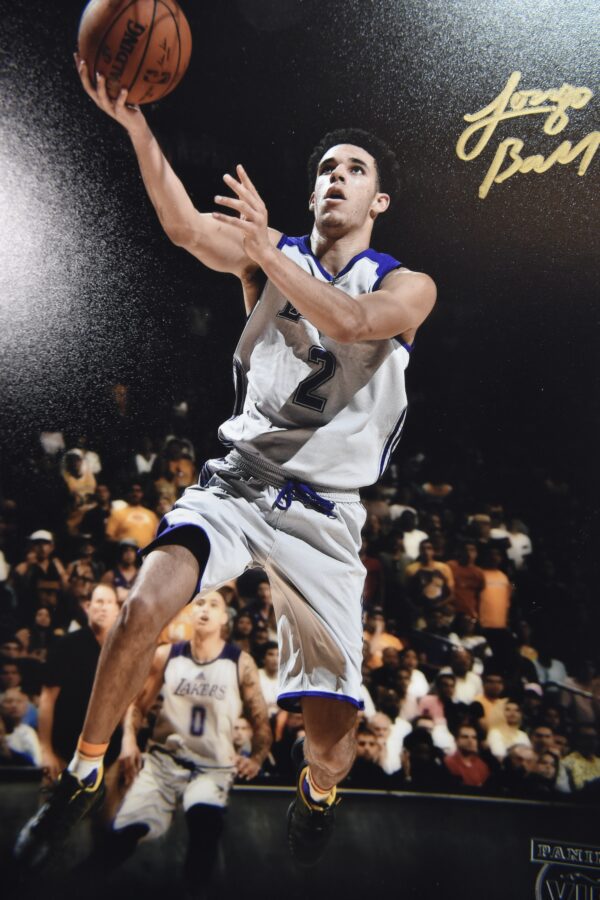 Lonzo Ball in Lakers jersey shooting basketball.