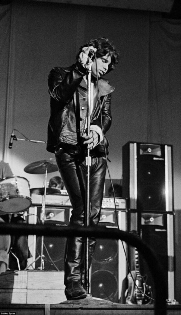 Black and white photo of Jim Morrison singing.