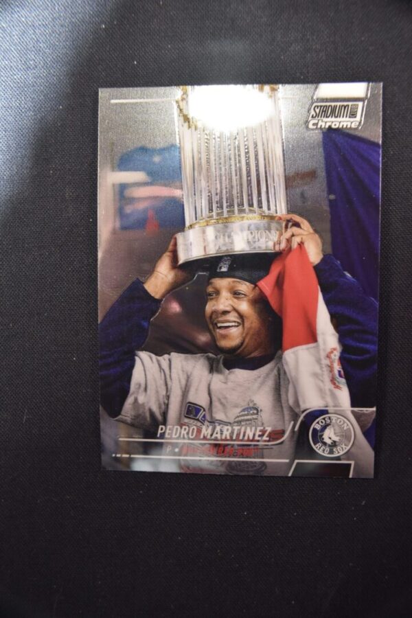 Pedro Martinez holding World Series trophy.