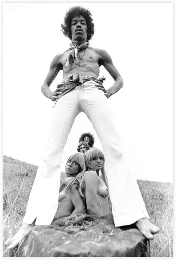 Jimi Hendrix and three women in black and white photo.