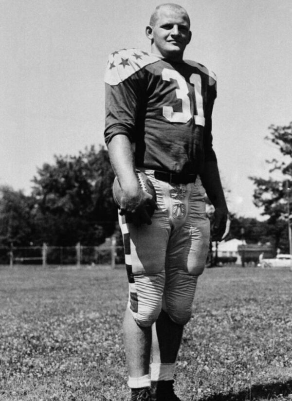 A football player in uniform on the field.