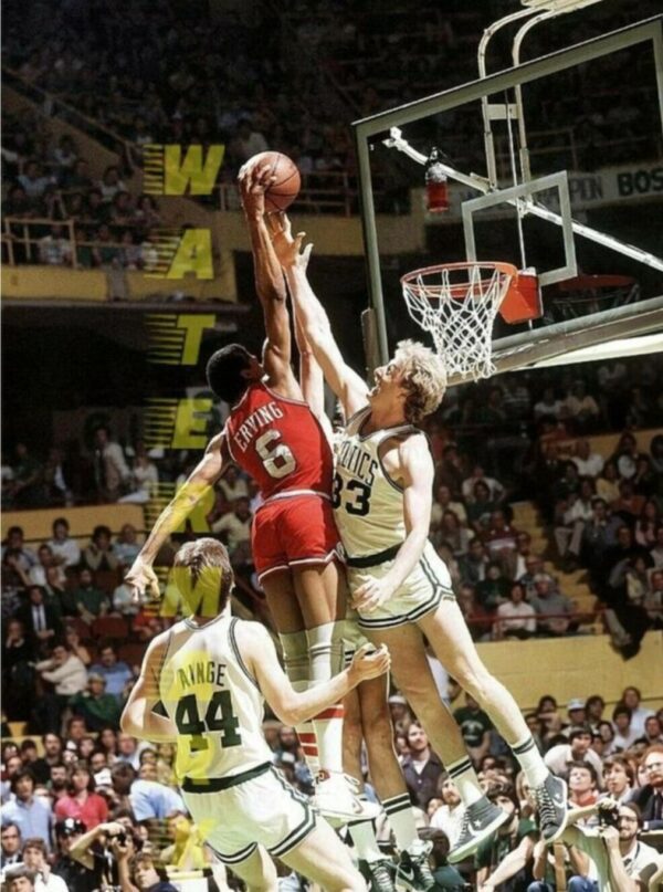 Basketball players jump for a shot.