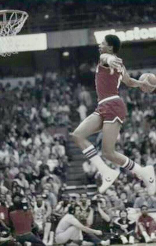 Basketball player in mid-air dunk.