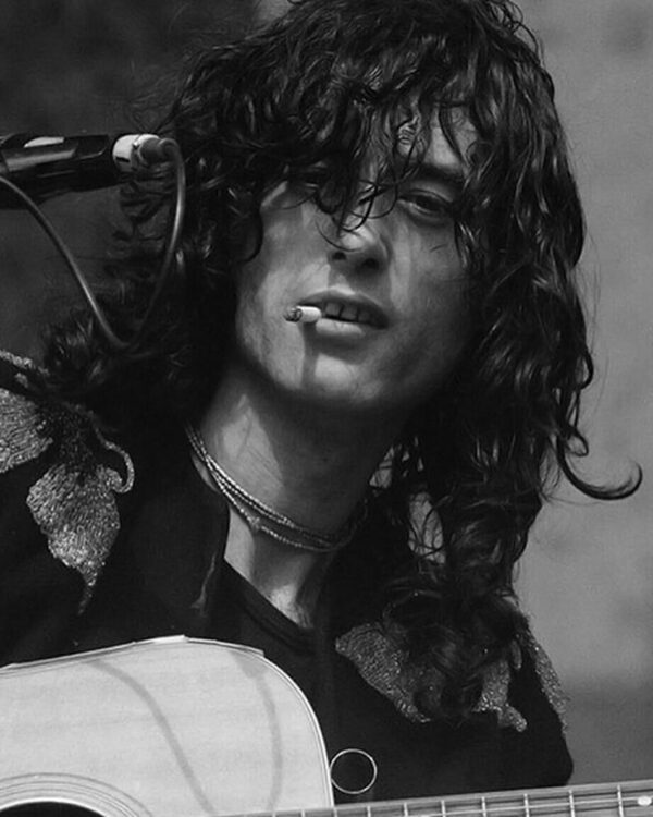 Black and white photo of a musician with a guitar.